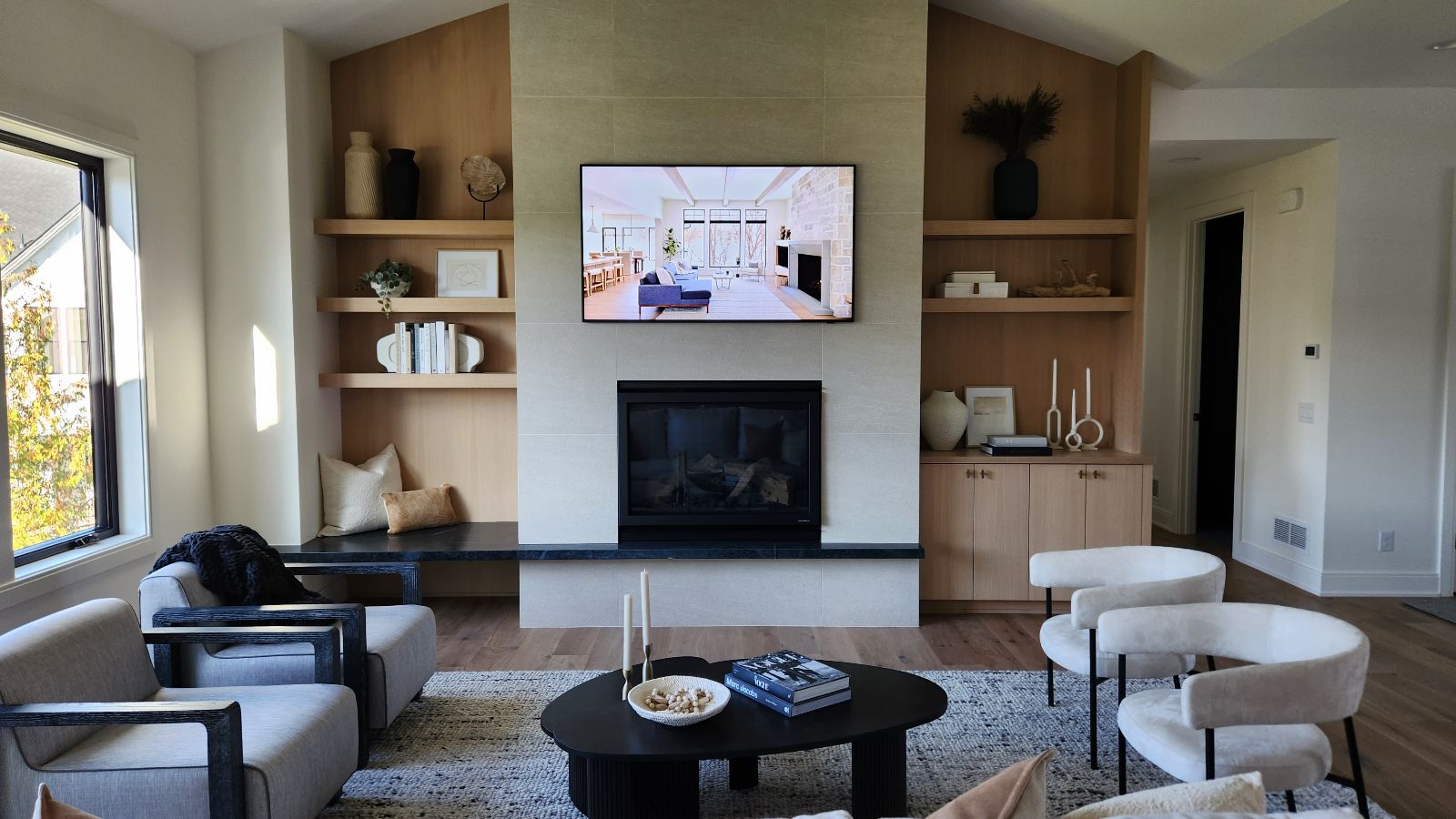 Modern living room with a wall-mounted TV above the fireplace