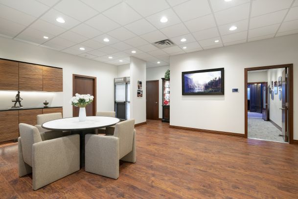 Open showroom space with meeting table and artwork