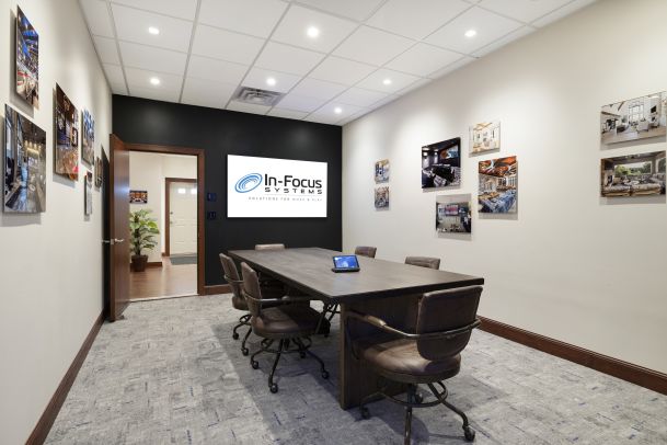 Consultation room with digital display and project photos