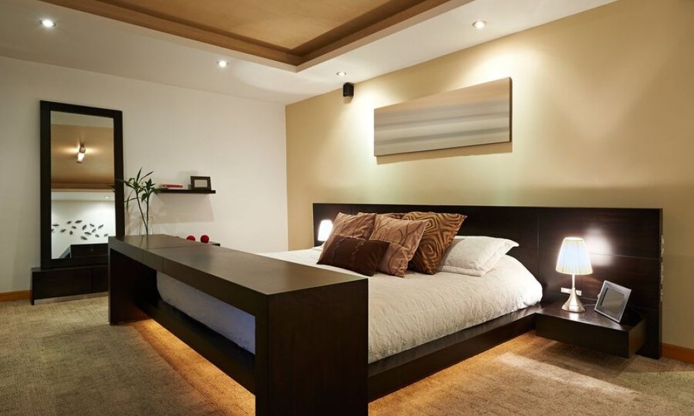 A bedroom illuminated by various smart lighting fixtures.