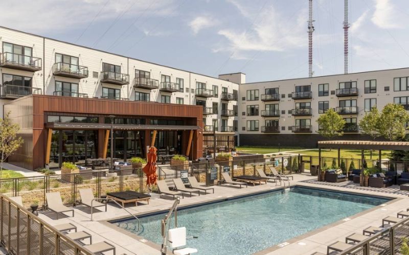<span class="uk-h4">Apartment complex pool with lounge chair seating all around. Speakers and security cameras are camouflaged in the decor.</span>